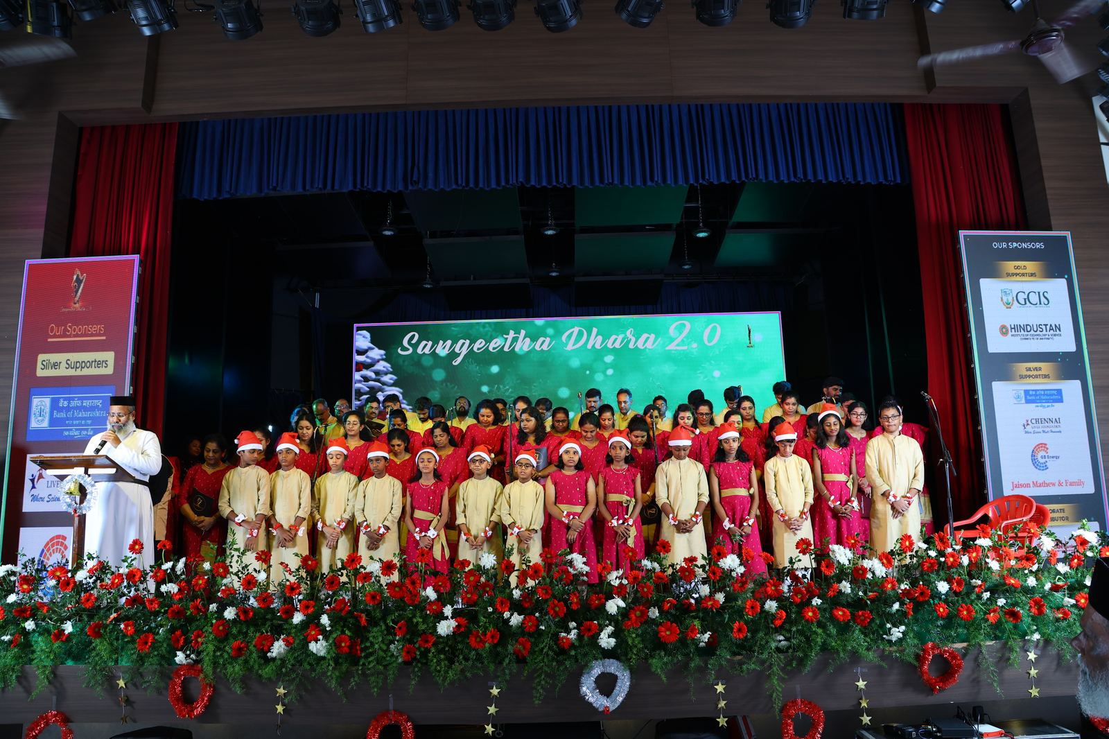 Choir children in Santa hats performing on stage